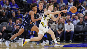 Nov 13, 2024; Orlando, Florida, USA; Indiana Pacers forward Johnny Furphy (12) passes the ball during the second quarter against the Orlando Magic at Kia Center. Mandatory Credit: Mike Watters-Imagn Images