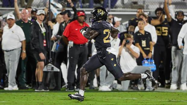 UCF Knights running back Myles Montgomery (22) runs the ball during the first quarter against the Kansas Jayhawks.