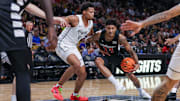 Feb 5, 2025; Orlando, Florida, USA; Cincinnati Bearcats forward Dillon Mitchell (23) drives to the basket against UCF Knights guard Keyshawn Hall (4) during the first half at Addition Financial Arena. Mandatory Credit: Mike Watters-Imagn Images
