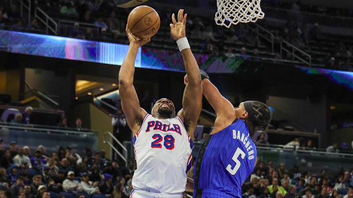 Jan 12, 2025; Orlando, Florida, USA; Philadelphia 76ers forward Guerschon Yabusele (28) goes to the basket against Orlando Magic forward Paolo Banchero (5) during the second quarter at Kia Center. Mandatory Credit: Mike Watters-Imagn Images