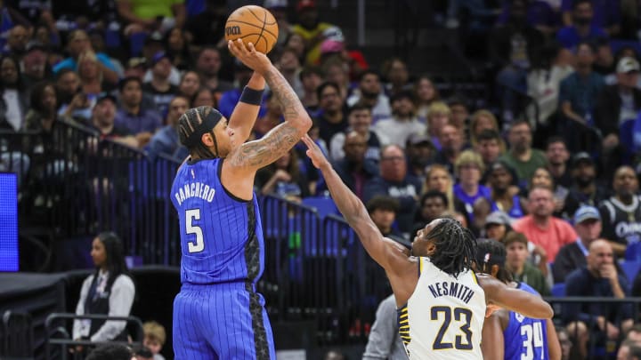 Mar 10, 2024; Orlando Magic forward Paolo Banchero (5) attempts a three-point basket against Indiana Pacers forward Aaron Nesmith (23) during the second half at KIA Center. 