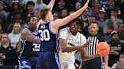 Jan 13, 2024; Orlando, Florida, USA; UCF Knights forward Thierno Sylla (31) looks to pass against Brigham Young Cougars guard Dallin Hall (30) during the first period at Addition Financial Arena. Mandatory Credit: Mike Watters-Imagn Images