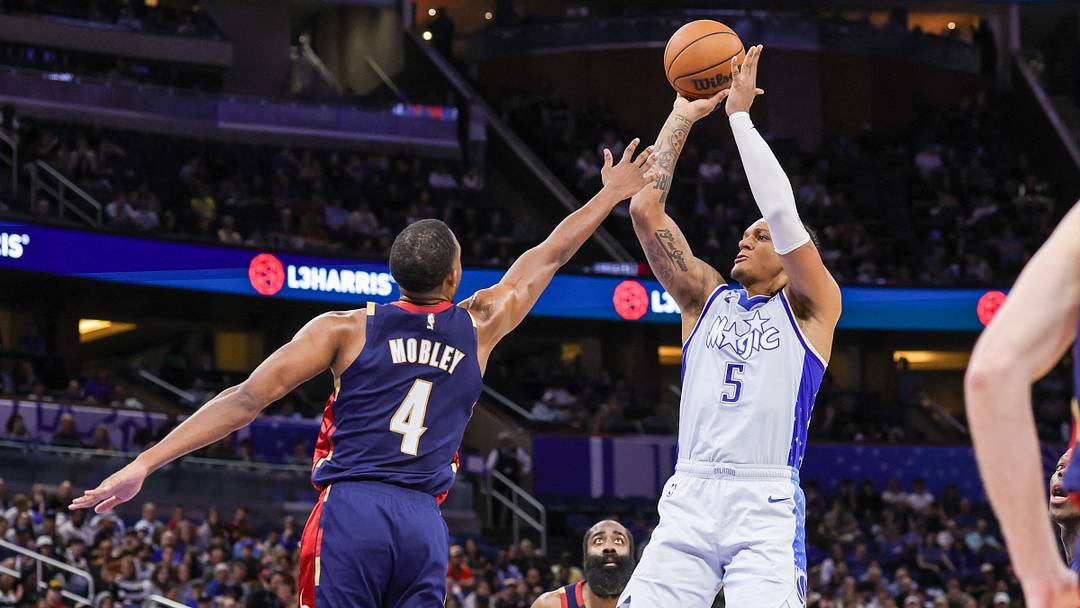 Mar 11, 2026; Orlando, Florida, USA; Orlando Magic forward Paolo Banchero (5) shoots over Cleveland Cavaliers center Evan Mobley (4) during the second quarter at Kia Center. Mandatory Credit: Mike Watters-Imagn Images