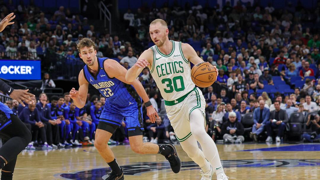 Apr 9, 2025; Orlando, Florida, USA; Boston Celtics forward Sam Hauser (30) brings the ball up court in front of Orlando Magic forward Franz Wagner (22) during the first quarter at Kia Center. Mandatory Credit: Mike Watters-Imagn Images