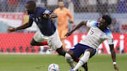Dec 10, 2022; Al Khor, Qatar; France defender Dayot Upamecano (18) and England midfielder Bukayo Saka (17) battle for the ball during the second half of a quarterfinal game in the 2022 FIFA World Cup at Al-Bayt Stadium. Mandatory Credit: Yukihito Taguchi-Imagn Images
