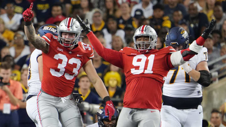 Sep 16, 2022; Columbus, Ohio, United States; Ohio State Buckeyes defensive end Jack Sawyer (33) and Ohio State Buckeyes defensive tackle Tyleik Williams (91) celebrate a sack of Toledo quarterback Dequan Finn during the Toledo game. Mandatory Credit: Doral Chenoweth/The Columbus Dispatch

Osu22tol Dc