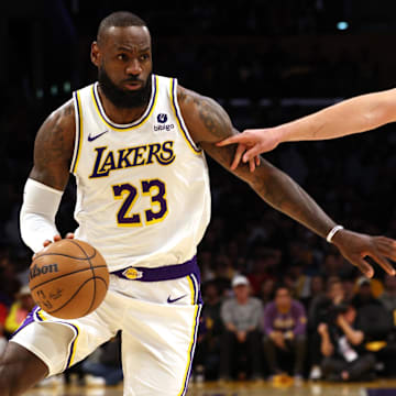 Apr 27, 2024; Los Angeles, California, USA; Los Angeles Lakers forward LeBron James (23) drives against Denver Nuggets center Nikola Jokic (15) during the first quarter in game four of the first round for the 2024 NBA playoffs at Crypto.com Arena. Mandatory Credit: Jason Parkhurst-Imagn Images