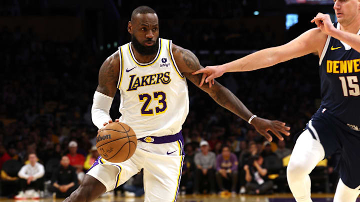 Apr 27, 2024; Los Angeles, California, USA; Los Angeles Lakers forward LeBron James (23) drives against Denver Nuggets center Nikola Jokic (15) during the first quarter in game four of the first round for the 2024 NBA playoffs at Crypto.com Arena. Mandatory Credit: Jason Parkhurst-Imagn Images