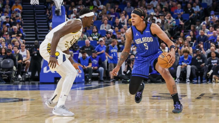 Mar 10, 2024; Orlando, Florida, USA; Orlando Magic forward Paolo Banchero (5) handles the ball against Indiana Pacers forward Pascal Siakam (43) during the first quarter at KIA Center. Mandatory Credit: Mike Watters-USA TODAY Sports