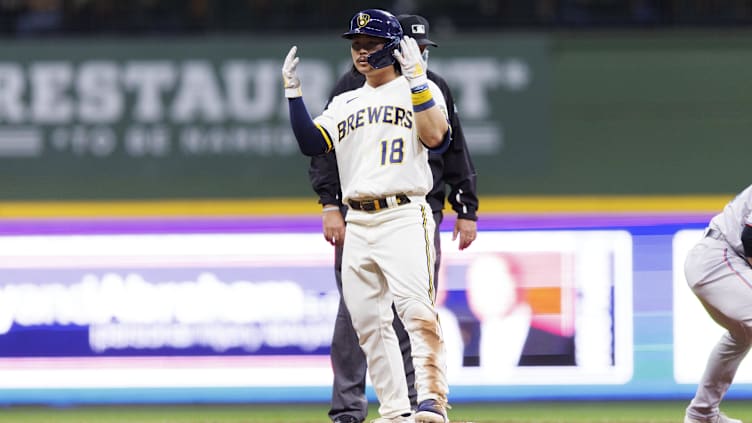 Milwaukee Brewers first baseman Keston Hiura (18) reacts after sliding into second base for a double. 