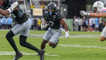 Nov 2, 2024; Orlando, Florida, USA; UCF Knights running back RJ Harvey (7) runs the ball against the Arizona Wildcats during the first quarter at FBC Mortgage Stadium. Mandatory Credit: Mike Watters-Imagn Images