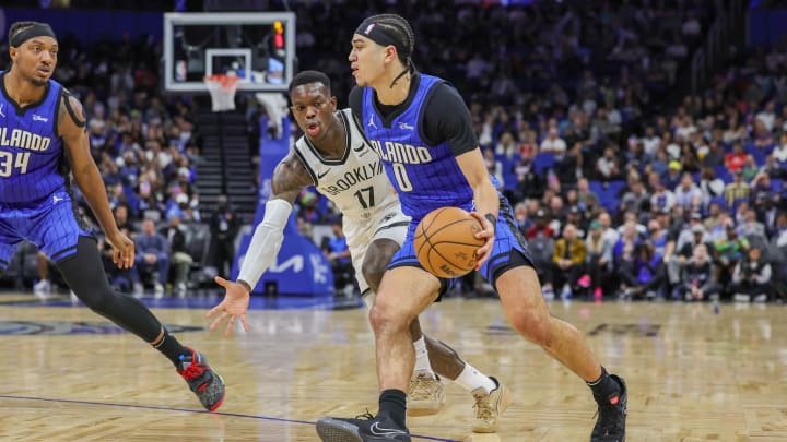 Orlando Magic guard Anthony Black (0) drives around Brooklyn Nets guard Dennis Schroder (17) during the second quarter at Amway Center. 