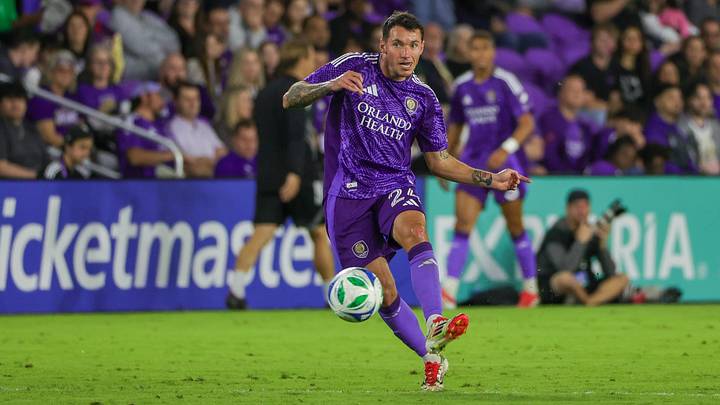 Mar 1, 2025; Orlando, Florida, USA; Orlando City defender Kyle Smith (24) kicks the ball during the second half against Toronto FC at Inter&Co Stadium. Mandatory Credit: Mike Watters-Imagn Images