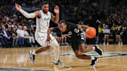 Feb 5, 2025; Orlando, Florida, USA; Cincinnati Bearcats guard Day Day Thomas (1) drives past UCF Knights guard Darius Johnson (3) during the first half at Addition Financial Arena. Mandatory Credit: Mike Watters-Imagn Images