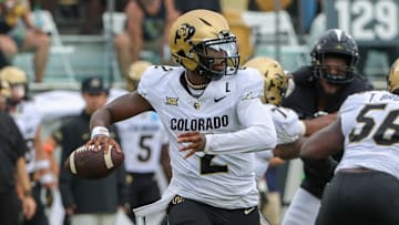 Sep 28, 2024; Orlando, Florida, USA; Colorado Buffaloes quarterback Shedeur Sanders (2) rolls out to pass against the UCF Knights during the first quarter at FBC Mortgage Stadium. Mandatory Credit: Mike Watters-Imagn Images