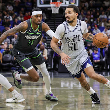Orlando Magic guard Cole Anthony (50) drives around Minnesota Timberwolves forward Jaden McDaniels (3) during the first quarter at Kia Center.