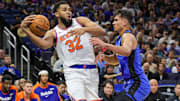 New York Knicks center Karl-Anthony Towns, defended here by Orlando Magic forward, Tristan da Silva, is listed as questionable for Sunday's matinee.