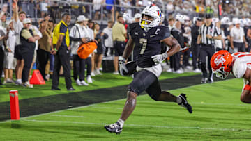 Sep 7, 2024; Orlando, Florida, USA; UCF Knights running back RJ Harvey (7) scores a touchdown during the second quarter against the Sam Houston State Bearkats at FBC Mortgage Stadium. Mandatory Credit: Mike Watters-Imagn Images