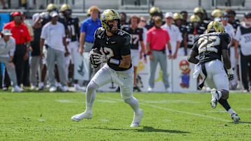 Sep 20, 2025; Orlando, Florida, USA; UCF Knights quarterback Tayven Jackson (2) rolls back to pass during the first quarter against the North Carolina Tar Heels at the Bounce House Stadium. Mandatory Credit: Mike Watters-Imagn Images