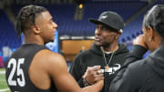 Mar 2, 2024; Indianapolis, IN, USA; NFL Hall of Fame player Jerry Rice talks to his son, USC wide receiver Brenden Rice.