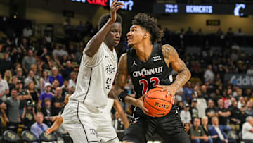 Feb 5, 2025; Orlando, Florida, USA; Cincinnati Bearcats forward Dillon Mitchell (23) goes to the basket against UCF Knights center Moustapha Thiam (52) during the first half at Addition Financial Arena. Mandatory Credit: Mike Watters-Imagn Images