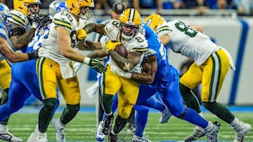 Green Bay Packers running back Josh Jacobs breaks through the Detroit Lions defensive line before being tackled during the Thursday Night Football game at Ford Field in Detroit on Thursday, Dec. 5, 2024. Jacobs scored three rushing touchdowns in the Lions' 34-31 win.