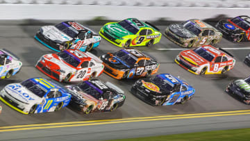 Aug 23, 2024; Daytona Beach, Florida, USA; Cars are three deep coming out of turn three during the Wawa 250 at Daytona International Speedway. Mandatory Credit: Mike Watters-USA TODAY Sports