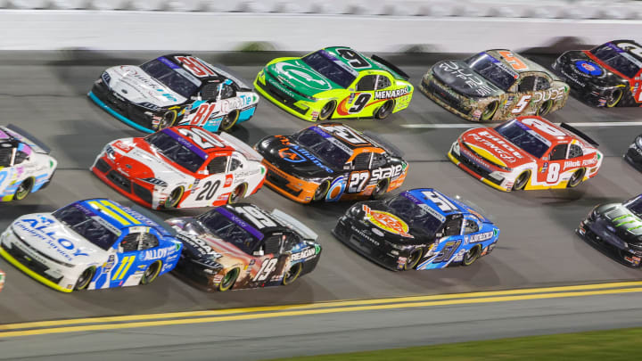 Aug 23, 2024; Daytona Beach, Florida, USA; Cars are three deep coming out of turn three during the Wawa 250 at Daytona International Speedway. Mandatory Credit: Mike Watters-USA TODAY Sports