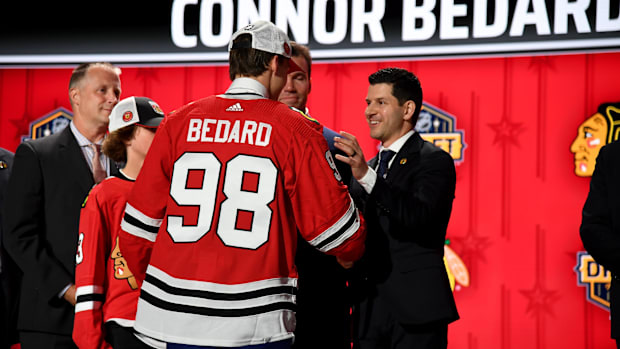 Chicago Blackhawks general manager Kyle Davidson congratulates Connor Bedard at the NHL Draft