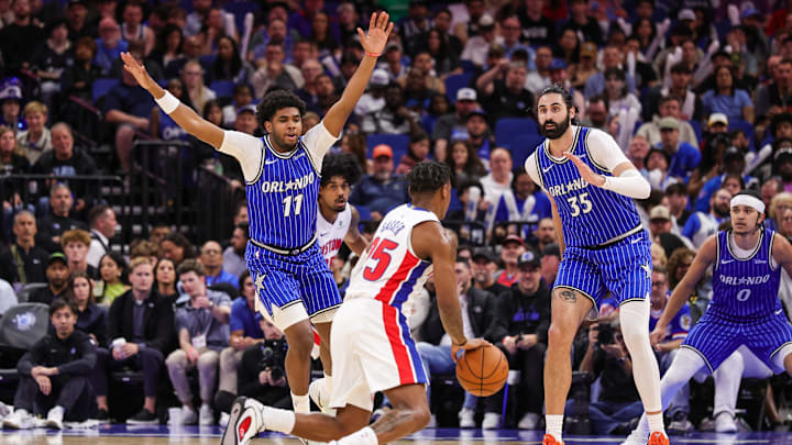 Apr 6, 2026; Orlando, Florida, USA; Orlando Magic guard Jase Richardson (11) and center Goga Bitadze (35) defend Detroit Pistons guard Marcus Sasser (25) during the second half at Kia Center. Mandatory Credit: Mike Watters-Imagn Images