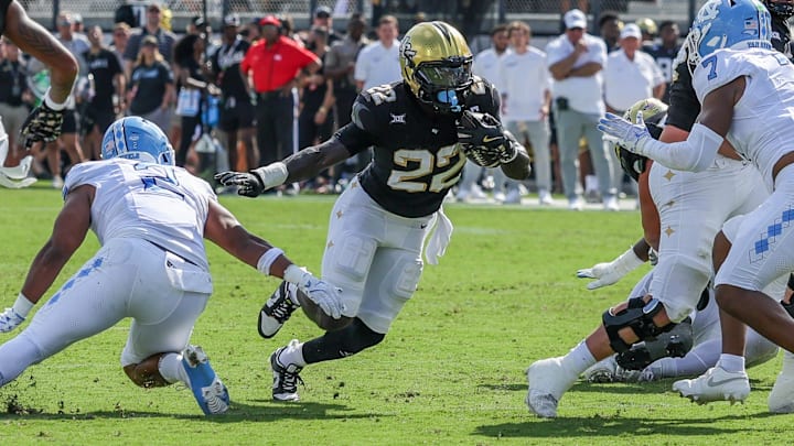 Sep 20, 2025; Orlando, Florida, USA; UCF Knights running back Myles Montgomery (22) carries the ball during the first quarter against the North Carolina Tar Heels at the Bounce House Stadium. Mandatory Credit: Mike Watters-Imagn Images