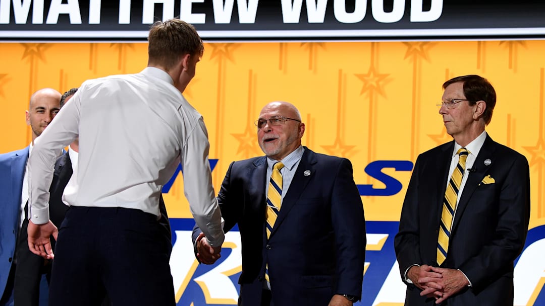 Jun 28, 2023; Nashville, Tennessee, USA; Nashville Predators draft pick Matthew Wood shakes hands with incoming general manager Barry Trotz after being selected with the fifteenth pick in round one of the 2023 NHL Draft at Bridgestone Arena. Mandatory Credit: Christopher Hanewinckel-Imagn Images