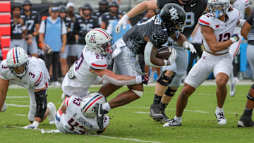 Nov 2, 2024; Orlando, Florida, USA; UCF Knights running back RJ Harvey (7) is tackled by Arizona Wildcats defensive back Owen Goss (27) during the first quarter at FBC Mortgage Stadium. 