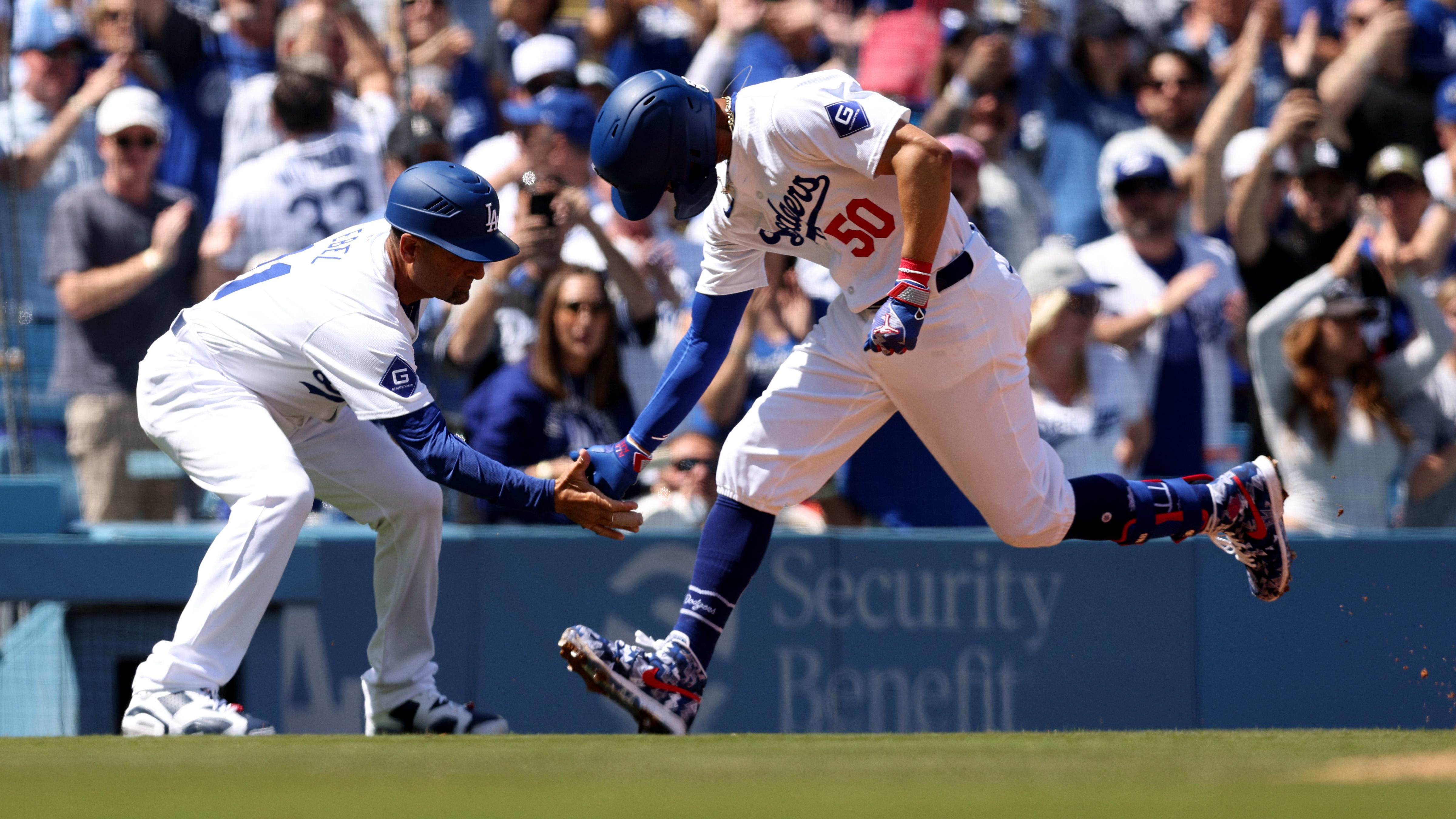Los Angeles Dodgers outfielder Mookie Betts rounds third base after a home run.