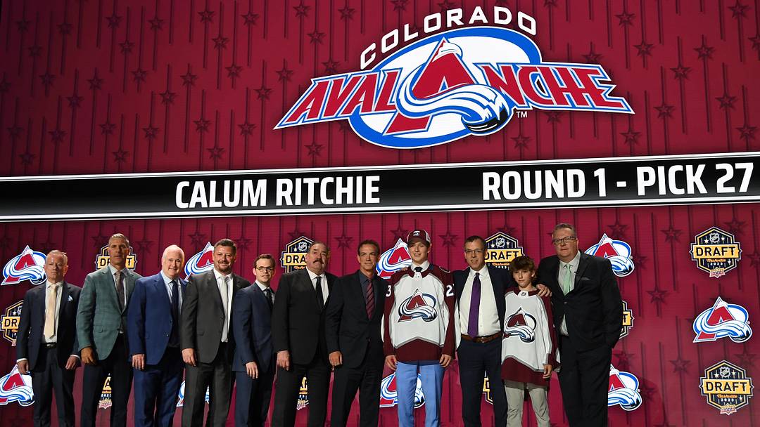 Jun 28, 2023; Nashville, Tennessee, USA; Colorado Avalanche draft pick Calum Ritchie stands with Ava staff after being selected with the thirty first pick in round one of the 2023 NHL Draft at Bridgestone Arena. Mandatory Credit: Christopher Hanewinckel-Imagn Images