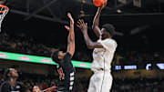 Feb 5, 2025; Orlando, Florida, USA; UCF Knights center Moustapha Thiam (52) shoots the ball against Cincinnati Bearcats forward Tyler Betsey (14) during the second half at Addition Financial Arena. Mandatory Credit: Mike Watters-Imagn Images