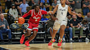 Nov 12, 2024; Orlando, Florida, USA; Florida Atlantic Owls guard Ken Evans Jr. (0) drives to the basket against UCF Knights guard Keyshawn Hall (4) during the first half at Addition Financial Arena. Mandatory Credit: Mike Watters-Imagn Images