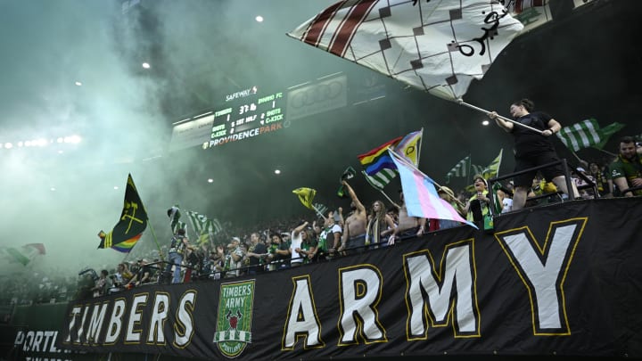 Jun 1, 2024; Portland, Oregon, USA; Portland Timbers fans celebrate a goal during the first half against the Houston Dynamo FC at Providence Park. Mandatory Credit: Troy Wayrynen-USA TODAY Sports
