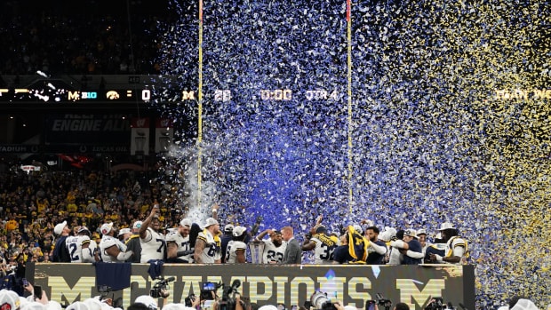 Michigan Wolverines celebrate after winning the Big Ten Championship game against the Iowa Hawkeyes at Lucas Oil Stadium.