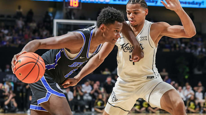 Feb 1, 2025; Orlando, Florida, USA; Brigham Young Cougars forward Kanon Catchings (6) drives around UCF Knights guard Keyshawn Hall (4) during the second half at Addition Financial Arena. Mandatory Credit: Mike Watters-Imagn Images