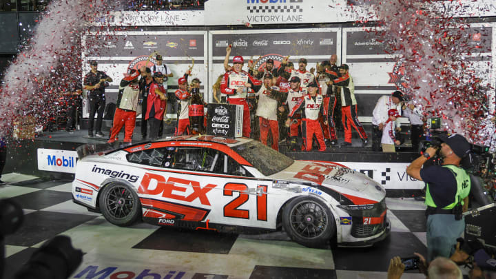 Aug 24, 2024; Daytona Beach, Florida, USA; NASCAR Cup Series driver Harrison Burton (21) celebrates on victory lane after winning the Coke 400 at Daytona International Speedway.