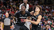 Feb 5, 2025; Orlando, Florida, USA; Cincinnati Bearcats forward Aziz Bandaogo (55), guard Dan Skillings Jr. (0) and UCF Knights center Moustapha Thiam (52) during the second half at Addition Financial Arena. Mandatory Credit: Mike Watters-Imagn Images