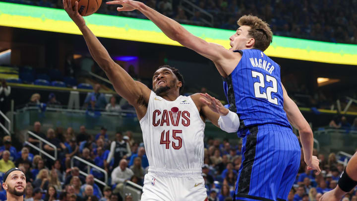 May 3, 2024; Orlando, Florida, USA; Orlando Magic forward Franz Wagner (22) blocks a shot by Cleveland Cavaliers guard Donovan Mitchell (45) during the first quarter of game six of the first round for the 2024 NBA playoffs at Kia Center. Mandatory Credit: Mike Watters-USA TODAY Sports