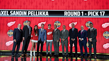 Jun 28, 2023; Nashville, Tennessee, USA; Detroit Red Wings draft pick Axel Sandin Pellikka stands with Red Wings staff after being selected with the seventeenth pick in round one of the 2023 NHL Draft at Bridgestone Arena. Mandatory Credit: Christopher Hanewinckel-Imagn Images
