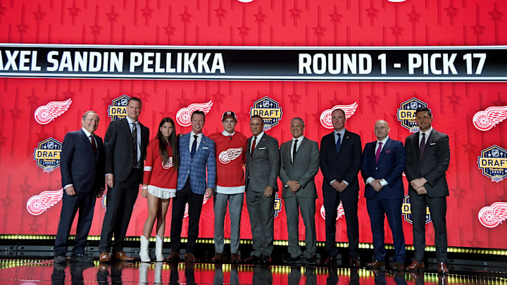 Jun 28, 2023; Nashville, Tennessee, USA; Detroit Red Wings draft pick Axel Sandin Pellikka stands with Red Wings staff after being selected with the seventeenth pick in round one of the 2023 NHL Draft at Bridgestone Arena. Mandatory Credit: Christopher Hanewinckel-Imagn Images