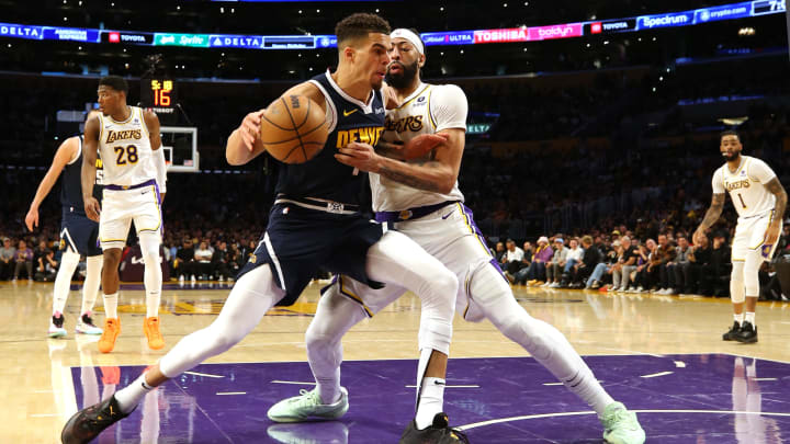 Apr 27, 2024; Los Angeles, California, USA; Denver Nuggets forward Michael Porter Jr. (1) battles for position with Los Angeles Lakers forward Anthony Davis (3) during the third quarter in game four of the first round for the 2024 NBA playoffs at Crypto.com Arena. Mandatory Credit: Jason Parkhurst-USA TODAY Sports