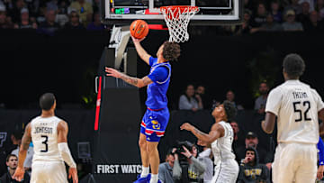 Jan 5, 2025; Orlando, Florida, USA; Kansas Jayhawks guard Zeke Mayo (5) goes to the basket against UCF Knights guard Jordan Ivy-Curry (0) during the first half at Addition Financial Arena. Mandatory Credit: Mike Watters-Imagn Images