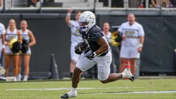 Oct 12, 2024; Orlando, Florida, USA; UCF Knights running back RJ Harvey (7) runs the ball during the first quarter against the Cincinnati Bearcats at FBC Mortgage Stadium. Mandatory Credit: Mike Watters-Imagn Images