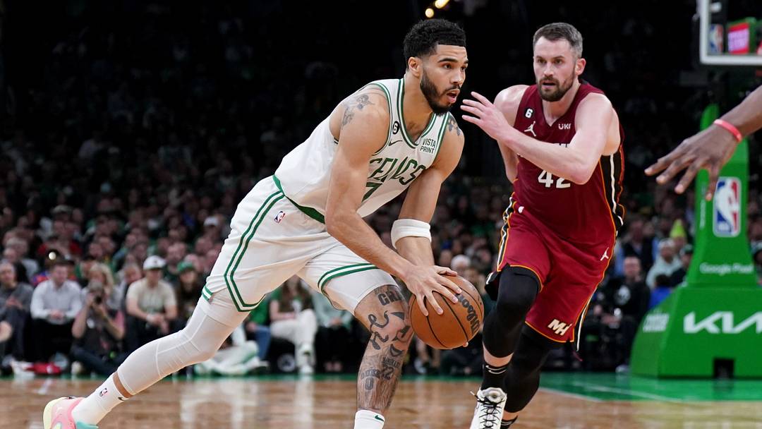May 19, 2023; Boston, Massachusetts, USA; Boston Celtics forward Jayson Tatum (0) drives in front of Miami Heat forward Kevin Love (42) during the first half of game two of the Eastern Conference Finals for the 2023 NBA playoffs at TD Garden. Mandatory Credit: David Butler II-Imagn Images