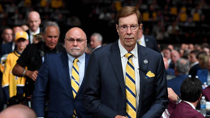 Jun 28, 2023; Nashville, Tennessee, USA; Nashville Predators outgoing general manager David Poile walks to the stage in front of incoming general manager Barry Trotz before the Predators make the fifteenth pick in round one of the 2023 NHL Draft at Bridgestone Arena. Mandatory Credit: Christopher Hanewinckel-Imagn Images